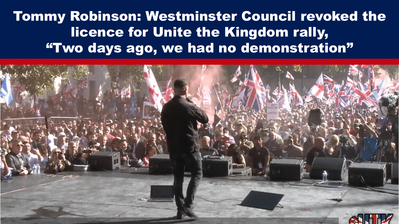 Expose News: Man on stage addressing lively crowd with flags at Unite the Kingdom rally; licence revoked by Westminster Council just two days prior.