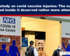 Editorial image: an NHS COVID-19 Vaccination Centre entrance with people wearing masks, accompanying a story about MHRA vaccine injury numbers.