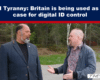 Two men standing outdoors and talking under a blue banner that reads 'Global Tyranny: Britain is being used as a test case for digital ID control'.
