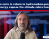 Video thumbnail showing a man with long hair and a scarf speaking into a microphone on a blue news set, with a headline about a climate crisis hoax at the top.