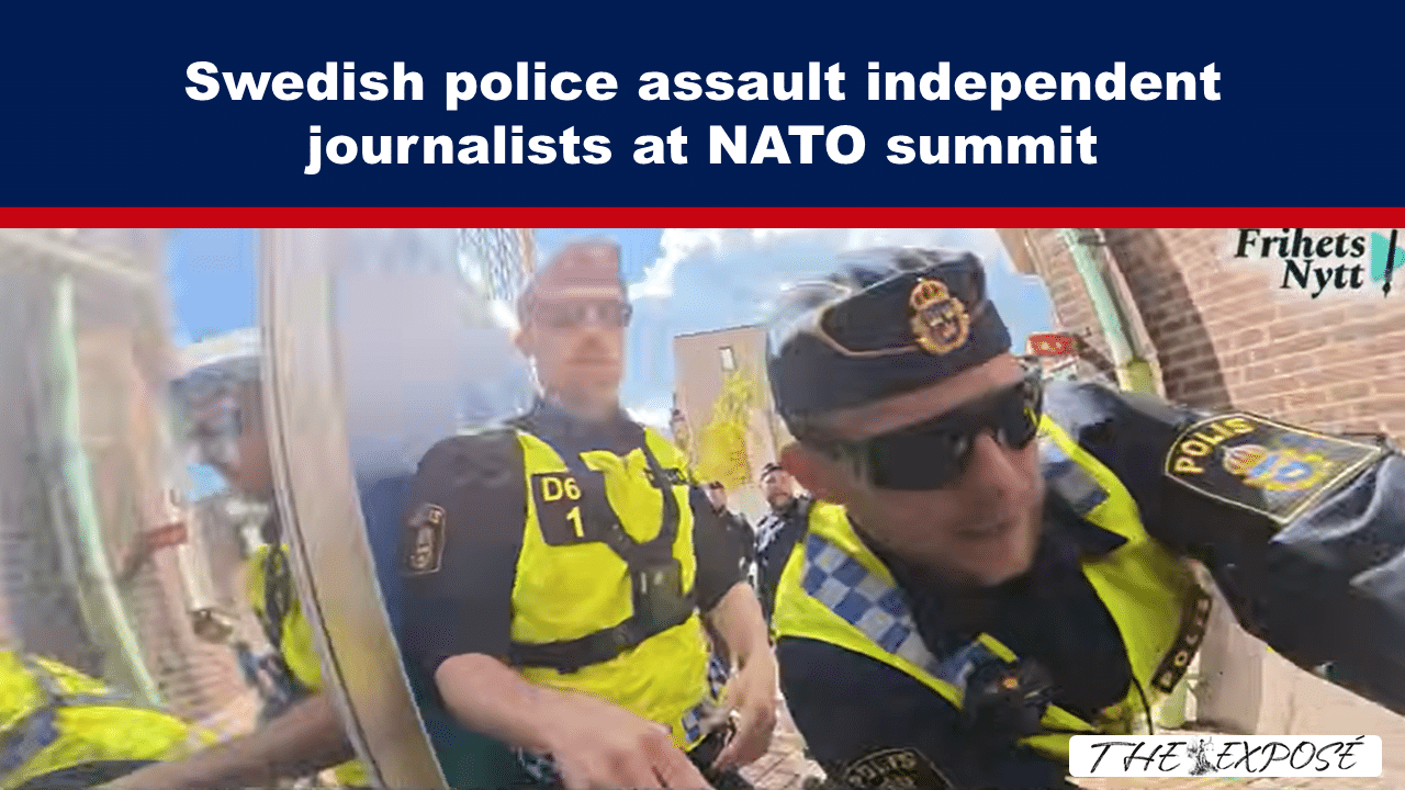 JunFeat8b - The Expose Police officers in high‑visibility vests confront independent journalists at a NATO summit protest, with a crowd in the background and a news logo in the corner