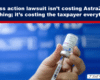 Headline banner stating 'UK class action lawsuit isn’t costing AstraZeneca anything; it’s costing the taxpayer everything' with a hand holding a syringe against a blue lab background.